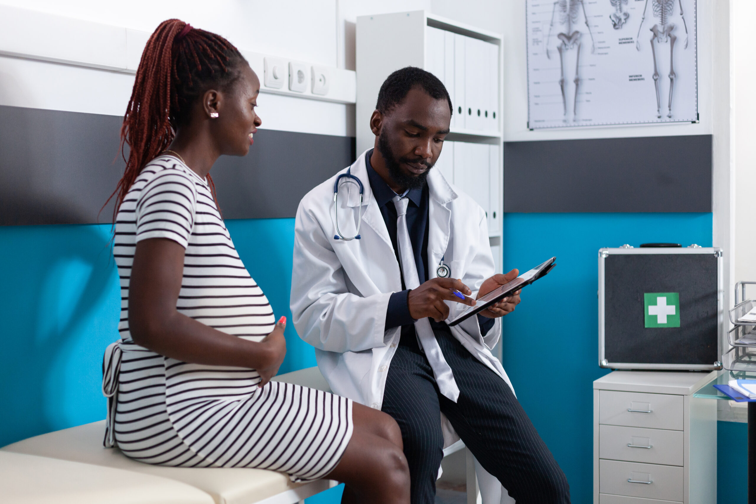 Woman expecting child and doing examination with medic